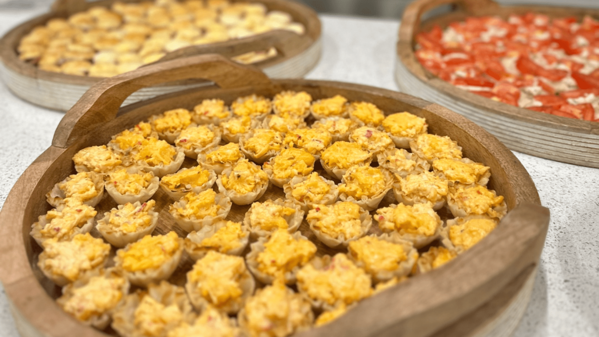 Catering food arranged on trays, featuring a variety of dishes ready to serve.