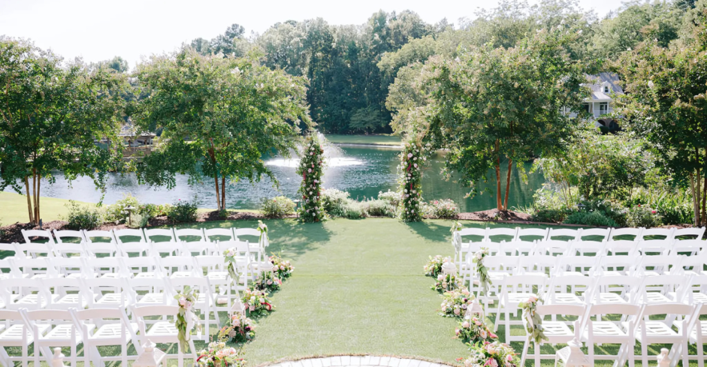 A scenic outdoor wedding ceremony setup by a lake in Wake County, NC.