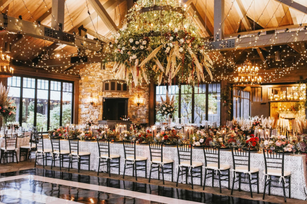 A beautifully decorated wedding reception venue with floral arrangements and elegant lighting in Wake County, NC.