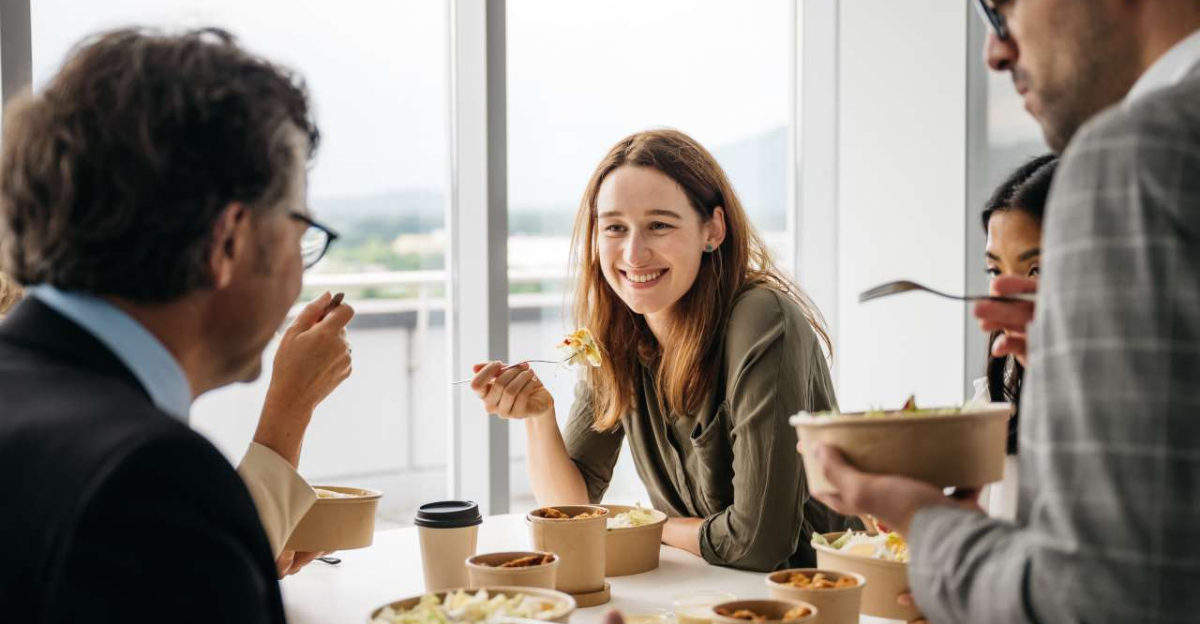 Employees gathered around table enjoying corporate lunch in Goldsboro office Caption: A great meal brings teams together—Bill’s Grill delivers corporate catering that fuels connection and productivity.