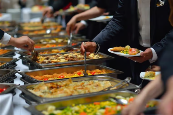 Professional corporate catering buffet setup in Jacksonville, NC with hot dishes and fresh salads